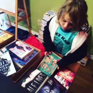 Thing 2 helping me pack boxes of books to take to the Rowlett Public Library